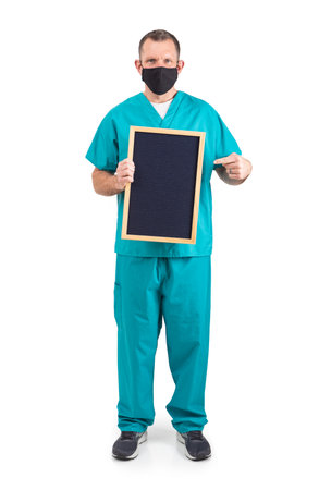 Male physician in scrubs and a mask, during the covid-19 pandemic.の写真素材
