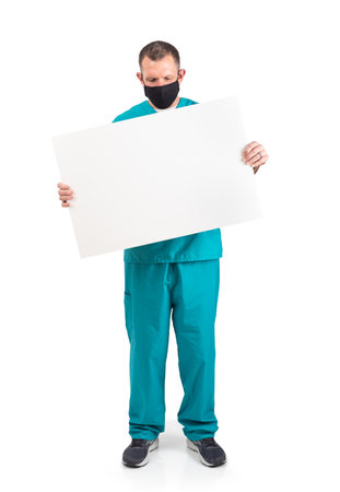 Male physician in scrubs and a mask, during the covid-19 pandemic.の写真素材