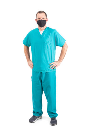 Male physician in scrubs and a mask, during the covid-19 pandemic.の写真素材