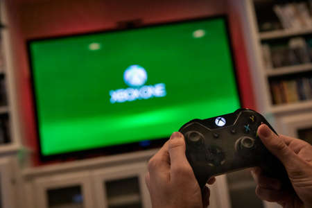 Modern, popular media and games being viewed on a large screen television through an Xbox One.のeditorial素材
