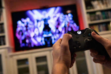 Modern, popular media and games being viewed on a large screen television through an Xbox One.のeditorial素材