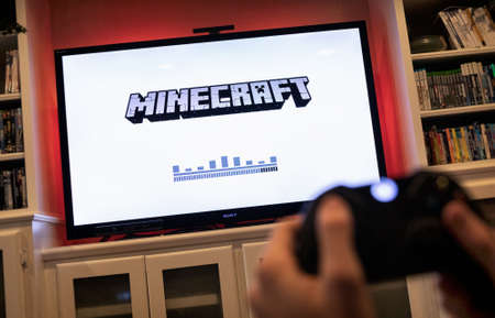 Modern, popular media and games being viewed on a large screen television through an Xbox One.のeditorial素材