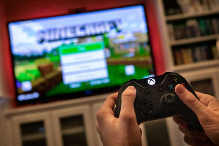 Modern, popular media and games being viewed on a large screen television through an Xbox One.のeditorial素材