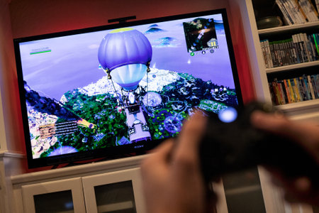 Modern, popular media and games being viewed on a large screen television through an Xbox One.のeditorial素材