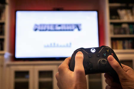 Modern, popular media and games being viewed on a large screen television through an Xbox One.のeditorial素材