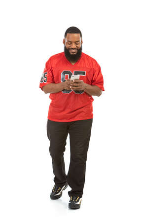 An African American man in a football team jersey in various poses.の写真素材