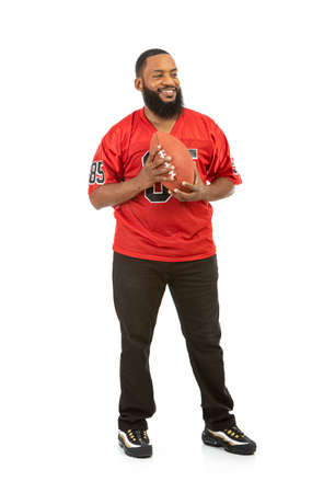 Fan: Side View of Man In Red Team Jersey With Footballの写真素材
