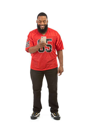 An African American man in a football team jersey in various poses.の写真素材