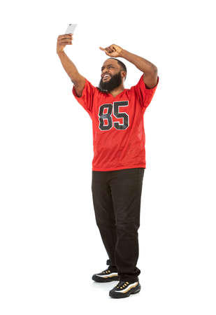 An African American man in a football team jersey in various poses.の写真素材