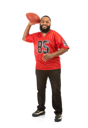 Fan: Happy Man In Red Team Jersey Throwing Footballの写真素材