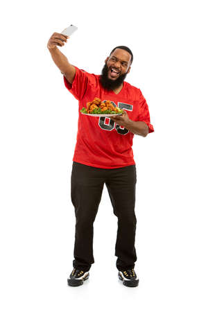 An African American man in a football team jersey in various poses.の写真素材