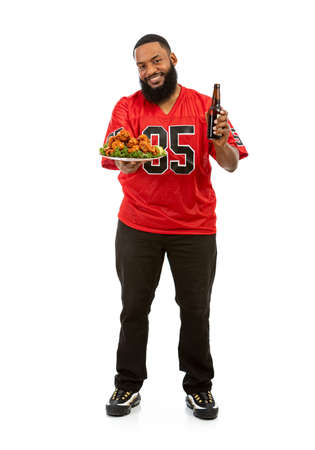 An African American man in a football team jersey in various poses.の写真素材