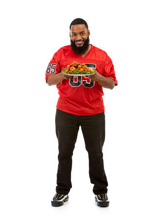 An African American man in a football team jersey in various poses.の写真素材