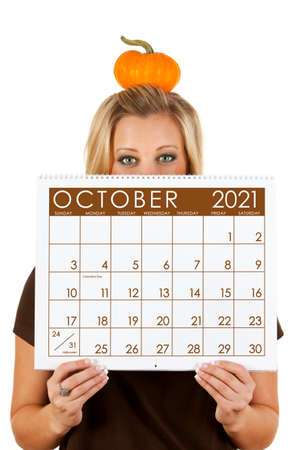 Cute series with a Caucasian woman holding a calendar for different times of the year.の写真素材