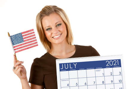 Cute series with a Caucasian woman holding a calendar for different times of the year.の写真素材