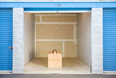 Caucasian man and woman with various props at a typical commercial storage unit.の写真素材