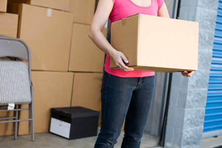 Caucasian man and woman with various props at a typical commercial storage unit.の写真素材