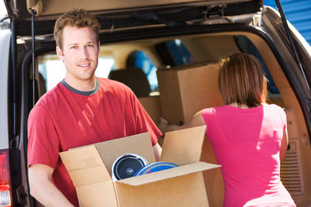 Caucasian man and woman with various props at a typical commercial storage unit.の写真素材
