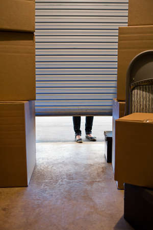 Caucasian man and woman with various props at a typical commercial storage unit.の写真素材