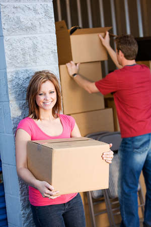 Caucasian man and woman with various props at a typical commercial storage unit.の写真素材