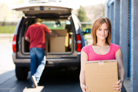 Caucasian man and woman with various props at a typical commercial storage unit.の写真素材