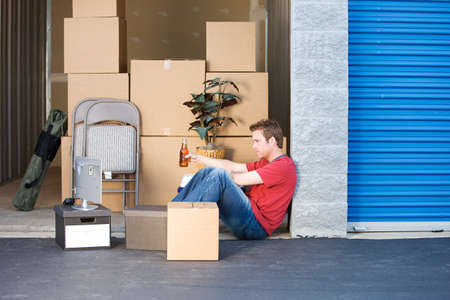 Caucasian man and woman with various props at a typical commercial storage unit.の写真素材