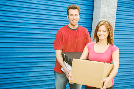 Caucasian man and woman with various props at a typical commercial storage unit.の写真素材