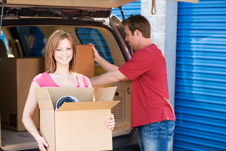 Caucasian man and woman with various props at a typical commercial storage unit.の写真素材
