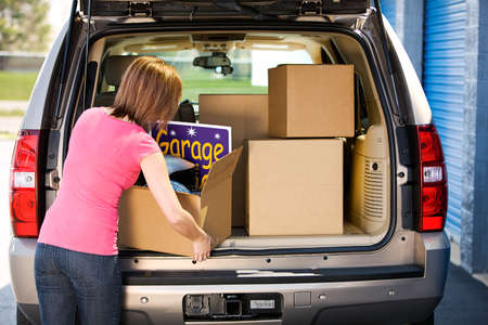 Caucasian man and woman with various props at a typical commercial storage unit.の写真素材