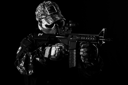 Young man with airsoft rifleの写真素材