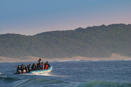 Divers on diveboat going to dive a reefの写真素材