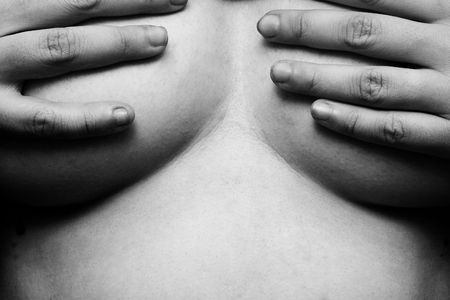 Womans hands on breastsの写真素材