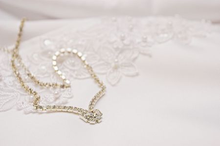 Bridal jewellery on wedding gownの写真素材