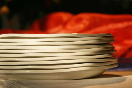 Plates stacked on a tableの写真素材