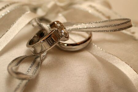 wedding rings lying on silkの写真素材