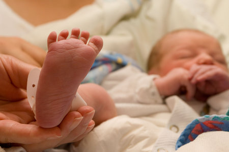 Foot of a new born baby - foot in focus, Face out of focus