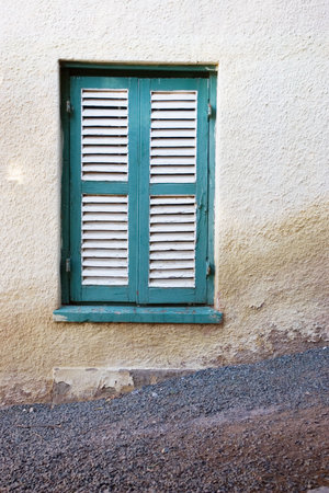 Turquois and white shuttered windowの写真素材