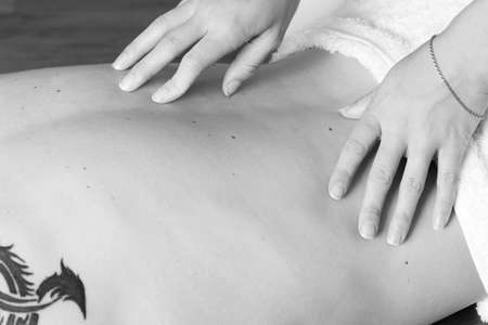 Masseuse working on a man - High Key BWの写真素材