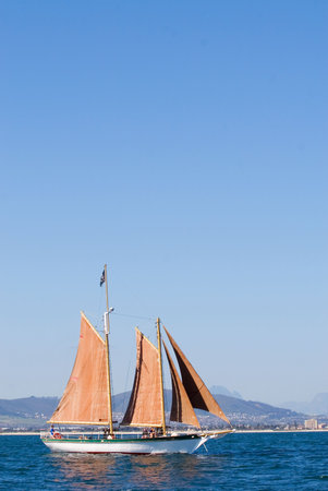 White Yacht, orange sail - copy space