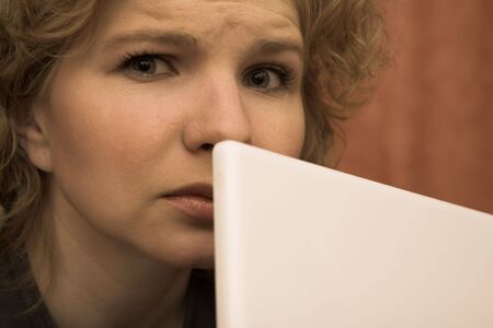 Worried Woman behind Notebook Computerの写真素材