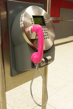 A dirty public payphone in a trainstation.