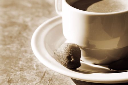 Coffee and a biscuit on a table.   Sepia, Copy spaceの写真素材