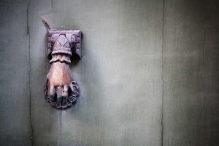 Door knocker in the form of a human hand.  Copy space.の写真素材