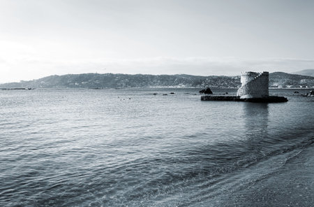 Ruins surrounded by water in Antibes, France.  Blue tone.  Copy space.