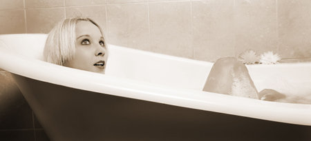  woman in a bath.  Sepia tone.