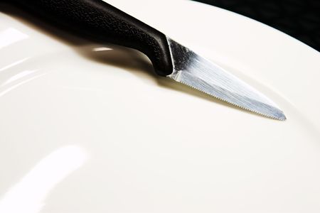  A knife on a white plate.の写真素材