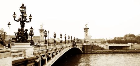 Pont Alexandre III - Bridge in Paris, France.  Movement on cars driving  Gloomy winters day. Copy space, sepia toneの写真素材