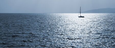 Single sailboat on the Mediterranean Sea  blue tone with Copy Spaceの写真素材