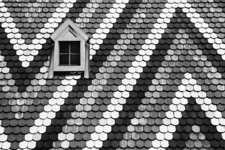 The roof and single window of St Stephens Cathedral in Vienna, Austriaの写真素材