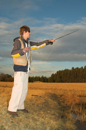 A fly fisherman casting a line in Dullstroom, South Africa